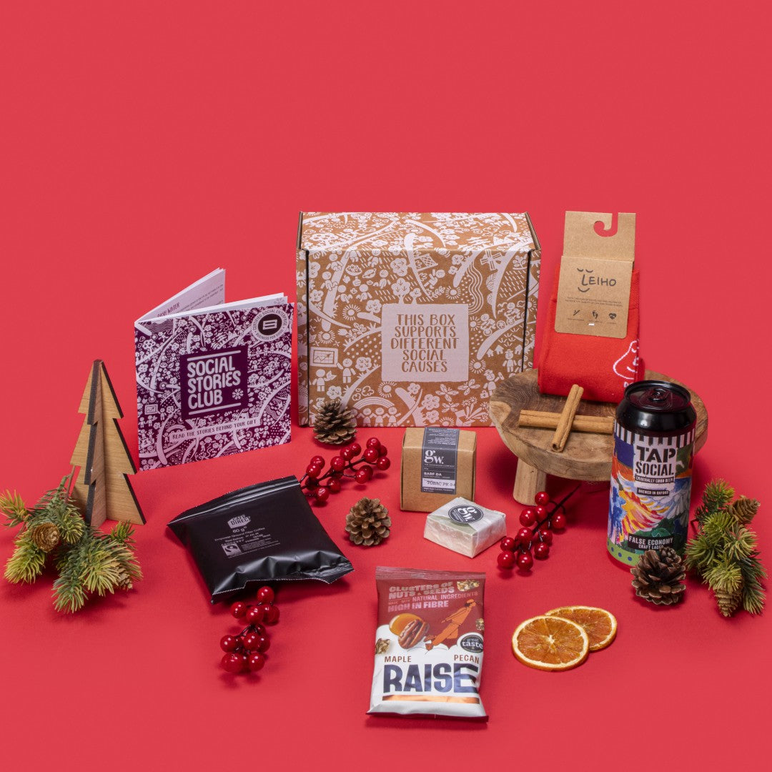 Sustainable Gift for Him open, showcasing smooth filter coffee, maple pecans, handmade beard bar, bamboo socks, craft lager, story booklet, and personalised note in rugged sustainable packaging with masculine festive accents.
