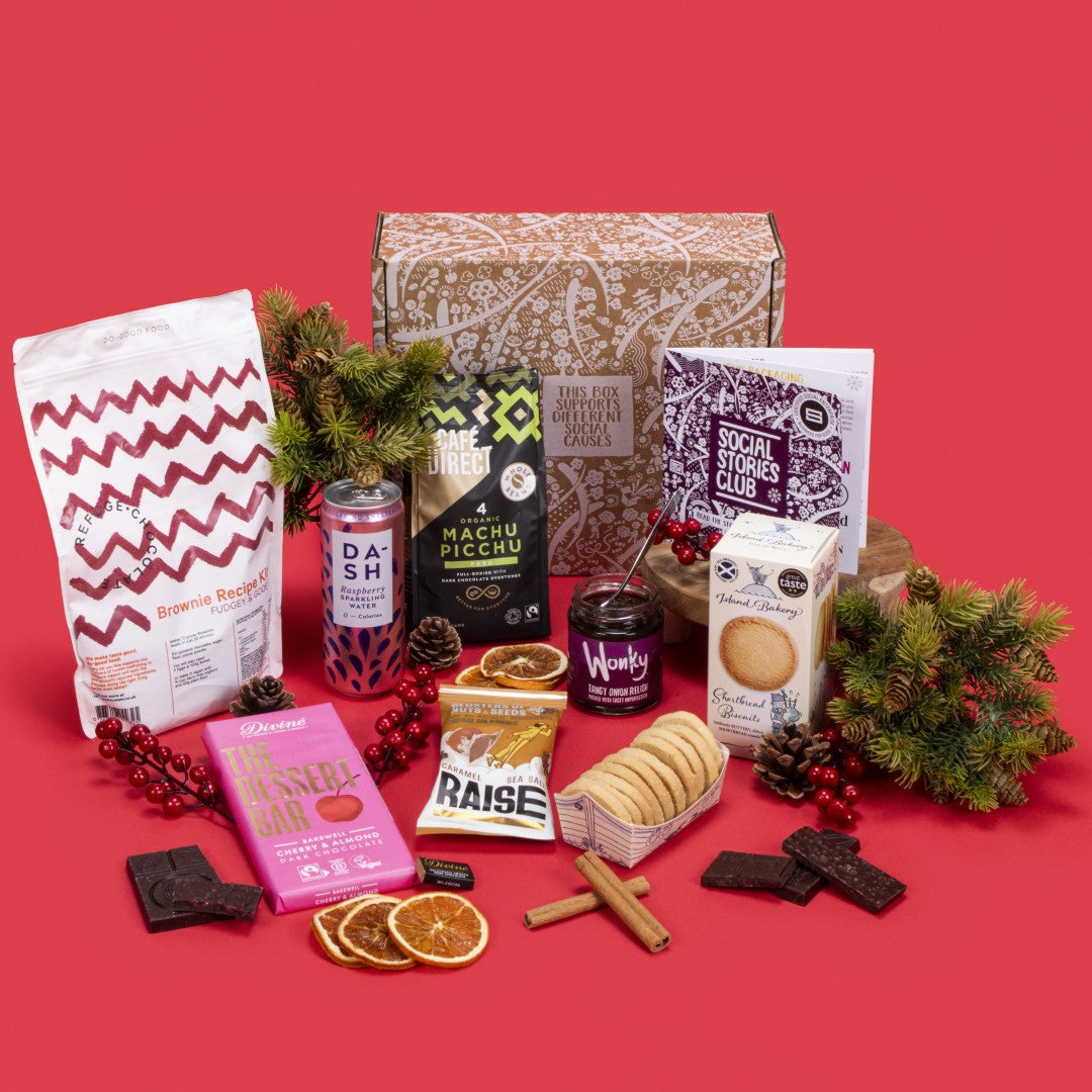Client Thank You Gift Box open, showcasing Machu Picchu coffee beans, shortbread biscuits, dark chocolate napolitain and Bakewell, fiery tomato relish, salted caramel seeds and nuts, raspberry sparkling water, brownie kit, story booklet, and personalised note in elegant sustainable packaging with festive warmth.