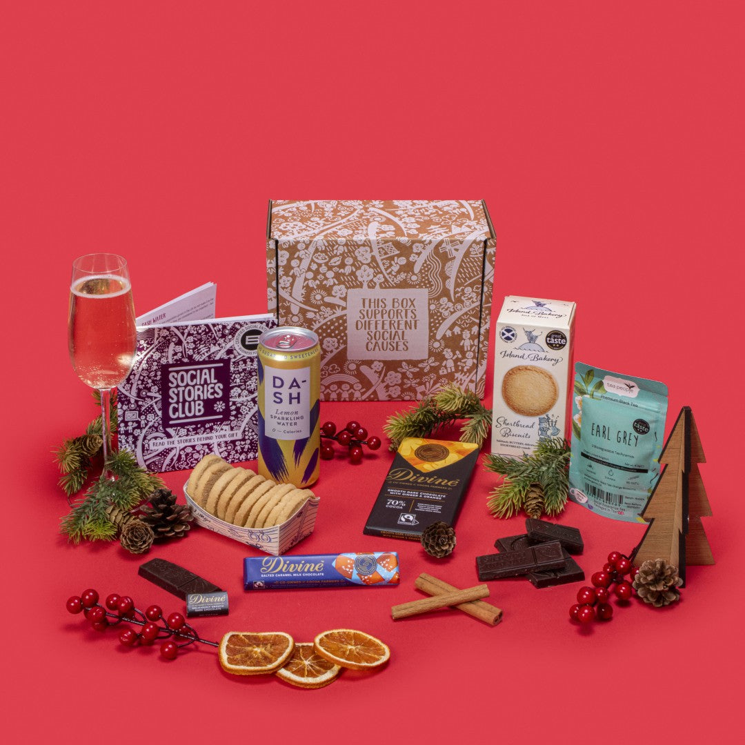 Conscious Collection open, displaying twin-pack Earl Grey tea, shortbread biscuits, ginger orange dark chocolate, salted caramel milk chocolate, napolitain, lemon sparkling water, story booklet & personalised note in elegant sustainable packaging with festive accents.