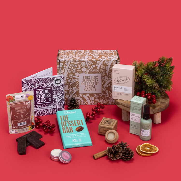 Luxury Self Care Gift Box open, revealing mulled wine tea, tiramisu chocolate, lavender candle, strawberry lip balm, pamper kit, bergamot lotion, story booklet, and personalised note in opulent sustainable packaging with serene festive accents.