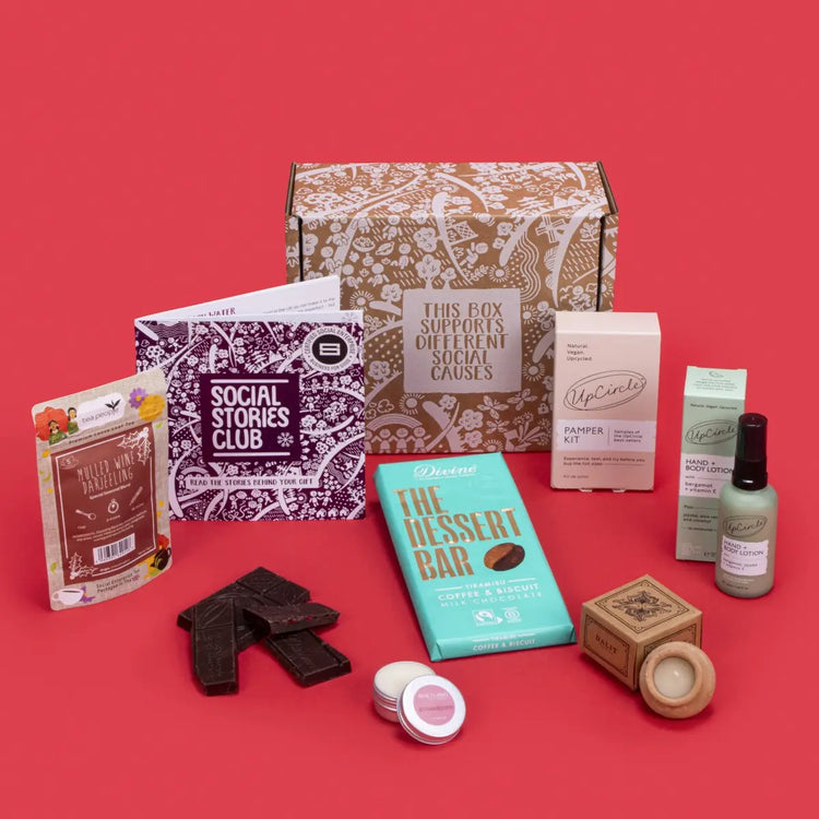 Luxury Self Care Gift Box open, revealing mulled wine tea, tiramisu chocolate, lavender candle, strawberry lip balm, pamper kit, bergamot lotion, story booklet, and personalised note in opulent sustainable packaging with serene festive accents.