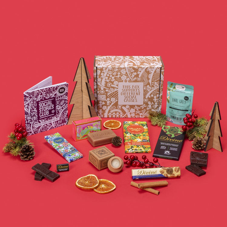 Pick Me Up Gift Box open, displaying twin-pack Earl Grey tea, sea salt caramel chocolate, orange dark chocolate, cappuccino chocolate, napolitain, hazelnut truffle chocolate, lavender candle, rosemary orange soap, story booklet & personalised note in uplifting sustainable packaging with festive accents.