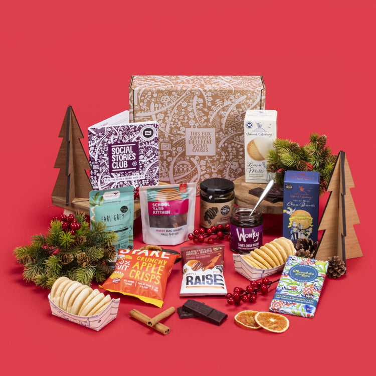 Sustainable Foodie Gift Box open, displaying Earl Grey tea twin-pack, lemon melt biscuits, cheese biscuits, sea salt caramel chocolate, apple crisps, fiery tomato relish, chilli pretzels, maple pecans, honey, story booklet & personalised note in gourmet sustainable packaging with festive accents.
