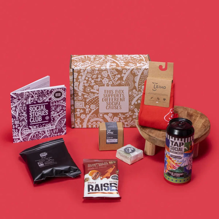 Sustainable Gift for Him open, showcasing smooth filter coffee, maple pecans, handmade beard bar, bamboo socks, craft lager, story booklet, and personalised note in rugged sustainable packaging with masculine festive accents.