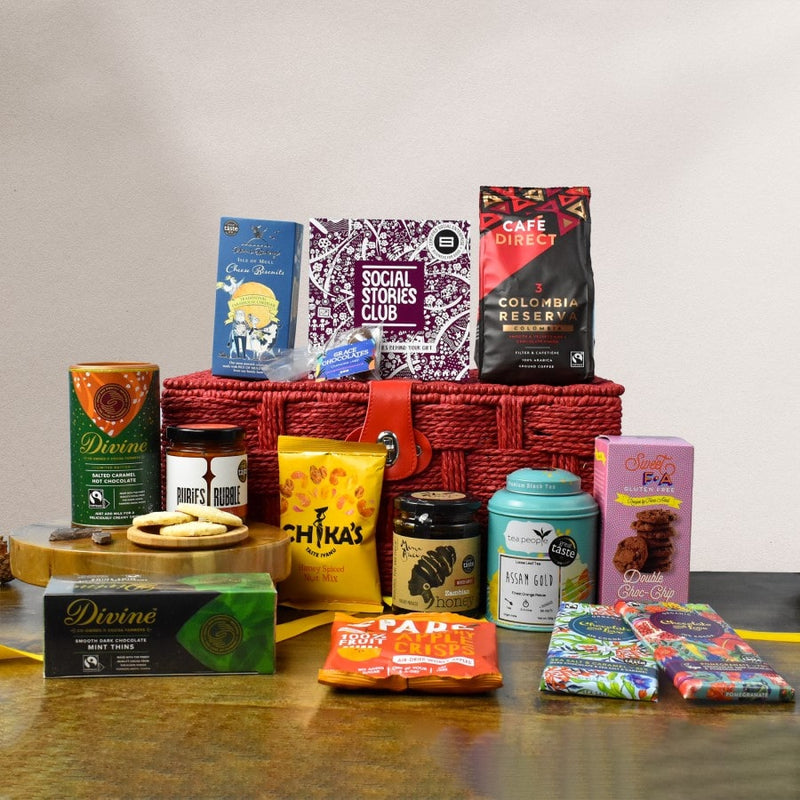 Traditional Food & Drink Gift Hamper. This is an image of a sustainable food gift. In this image is a sustainable gift hamper which is surrounded by social enterprise foodie products with social stories.
