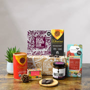 Vegan Treats Gift Box - This is an image of a plant based gift. In this image is a sustainable gift box which is surrounded by social enterprise vegan products with social stories. Best vegan gift.
