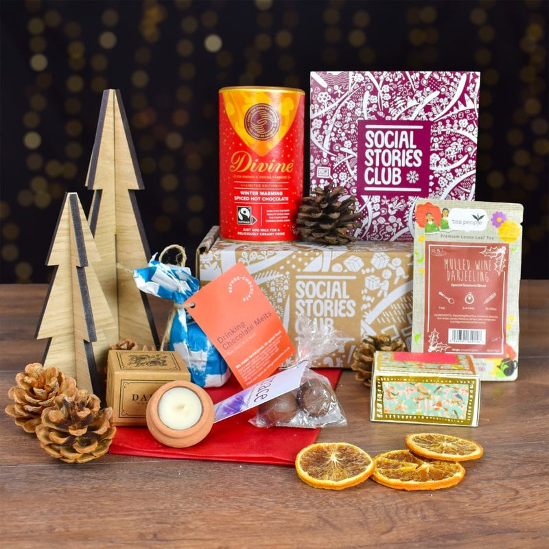 Winter Warmer Gift Box featuring ethical treats like mulled wine tea, organic soap, and winter-spiced hot chocolate, all supporting social and environmental causes.