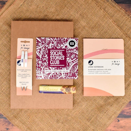 Journaling Letterbox Gift featuring an A5 journal, ethical chocolate, and recycled pencils, all supporting global education and social causes.