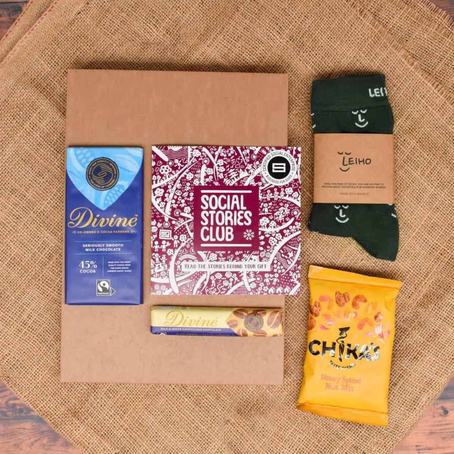 Letterbox Socks Gift Box with eco-friendly bamboo socks, dark chocolate with raspberries, and honey spiced nut mix, all supporting social causes.