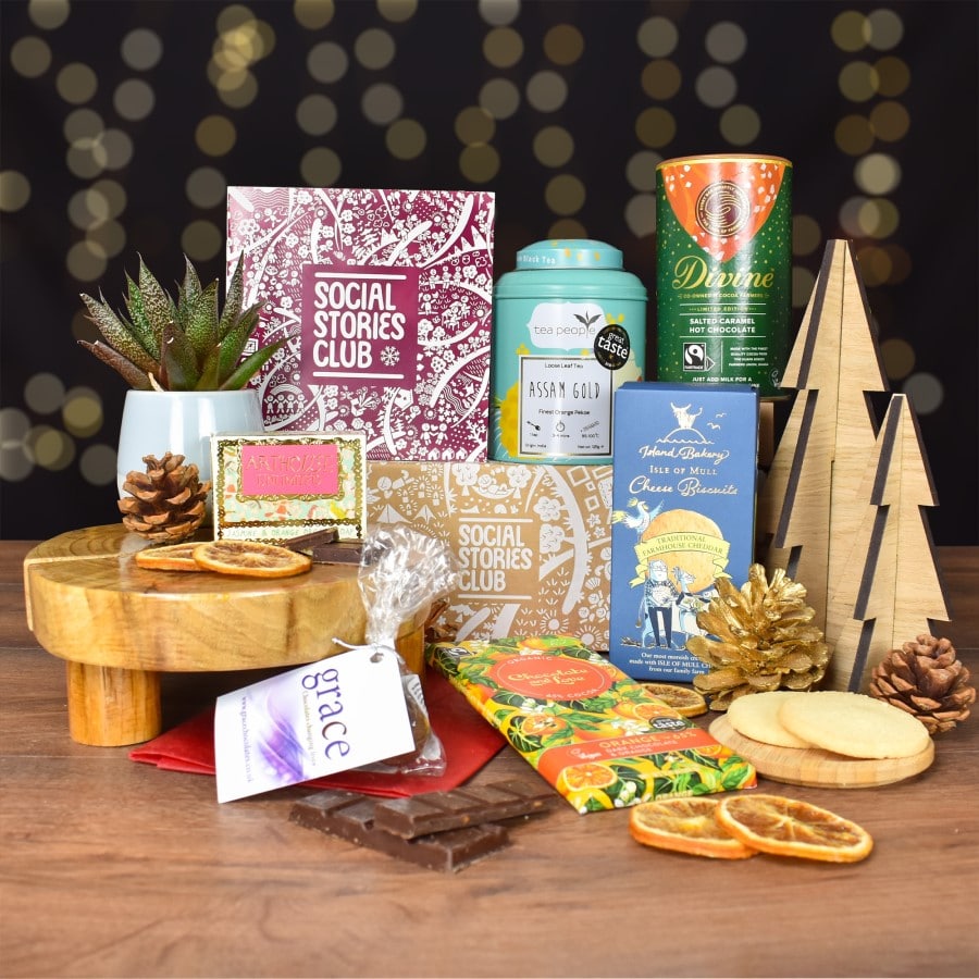 Eco-friendly Sustainable Christmas Gift Box featuring ethical products like handmade chocolate truffles, organic soap, and Assam Gold Tea, supporting social causes.